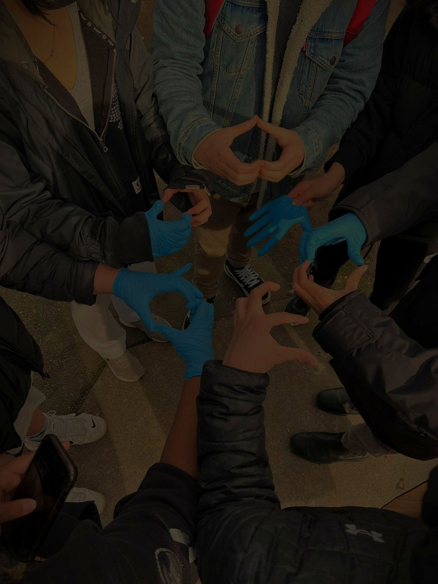 Volunteers' hands joined together making heart shapes